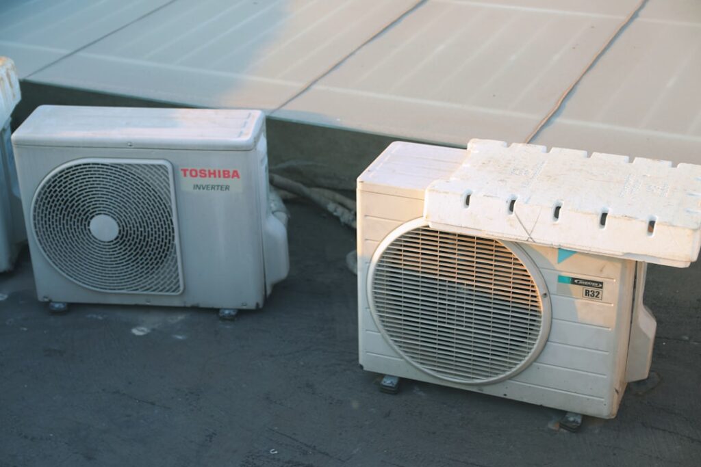 A homeowner changing an HVAC system air filter in a residential utility room.